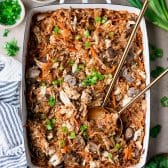 Easy egg roll casserole with coleslaw mix in a white baking dish.