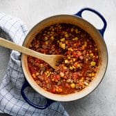 Cooking ground beef with corn and tomato sauce in a dutch oven.
