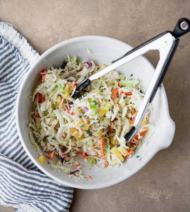 Process shot showing how to make pineapple slaw.