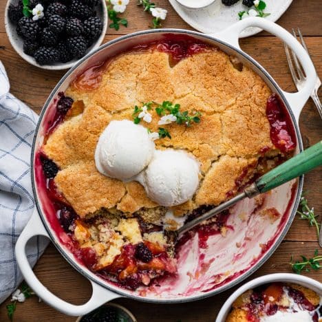 Square overhead image of old fashioned peach blackberry cobbler.