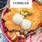 Peach blackberry cobbler with text title overlay.