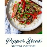 Pepper steak with onion and text title at the bottom.