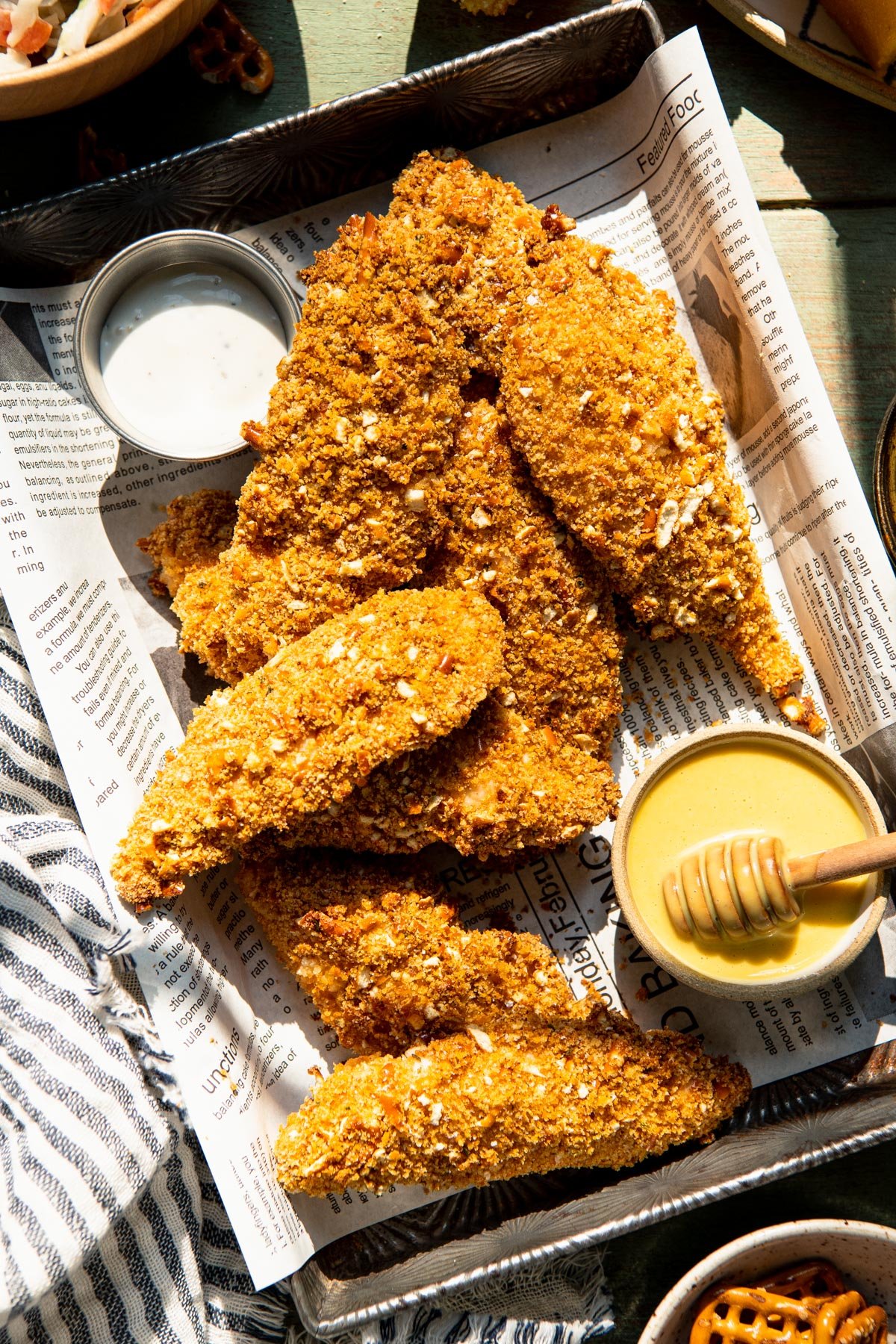 Close overhead shot of a tray of pretzel crusted chicken.