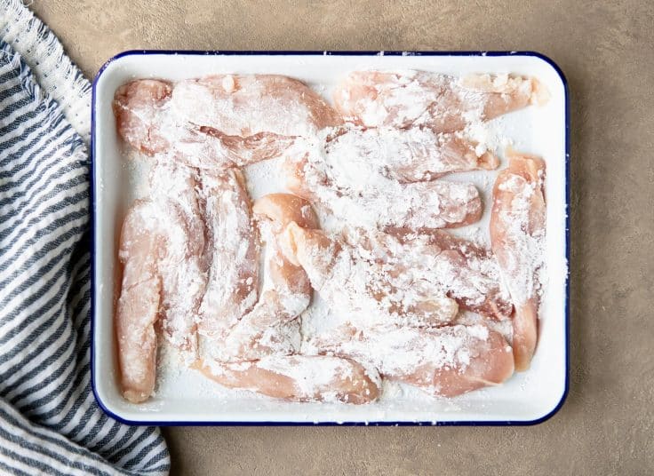Chicken breasts sliced into strips and coated in cornstarch.