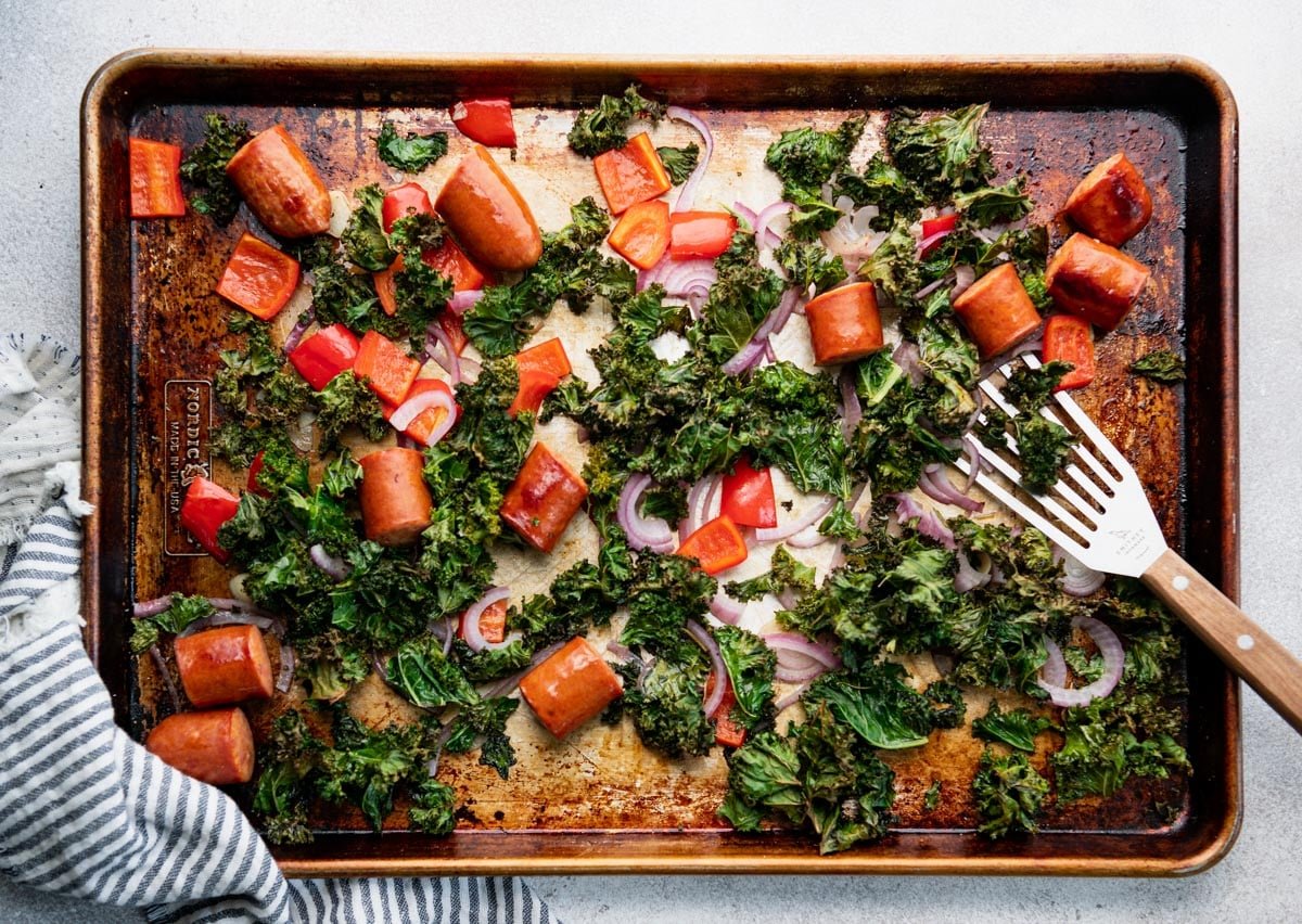 Sheet pan andouille sausage recipe with vegetables after baking.