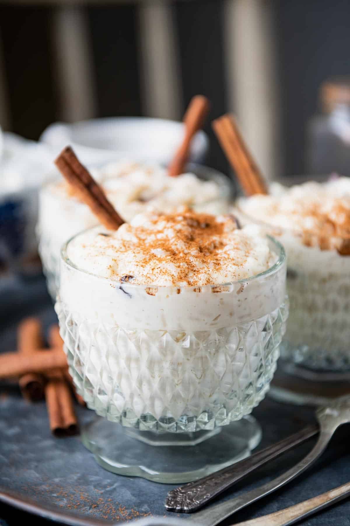 Side shot of southern rice pudding in vintage glass dishes.