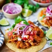 Close up shot of chicken tostada on a cutting board.