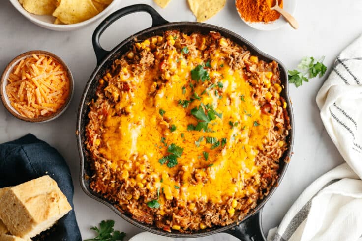 Horizontal overhead image of Texas hash in a skillet with fresh cilantro for garnish on top.