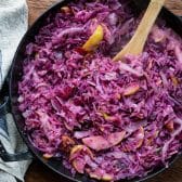 Sauteing red cabbage in bacon grease with apples and onions.