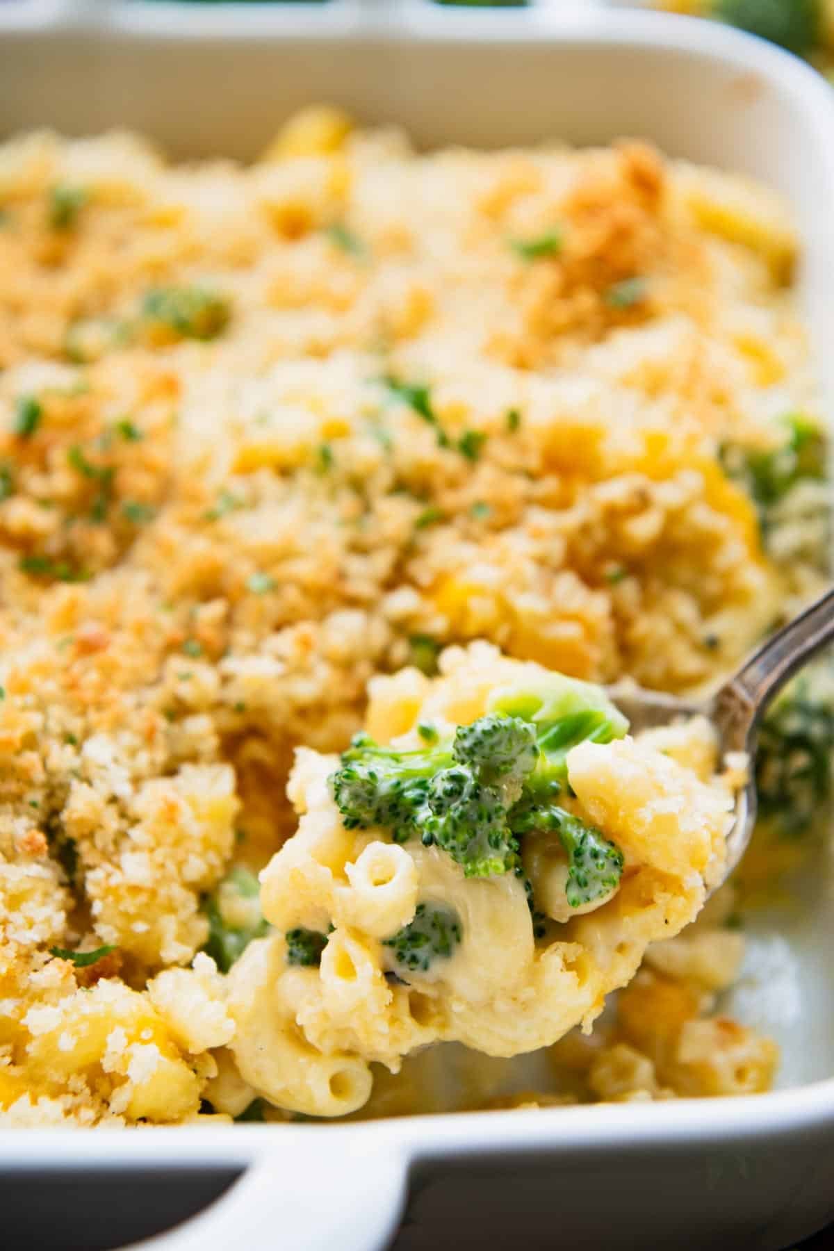 Close up side shot of broccoli mac and cheese on a serving spoon.
