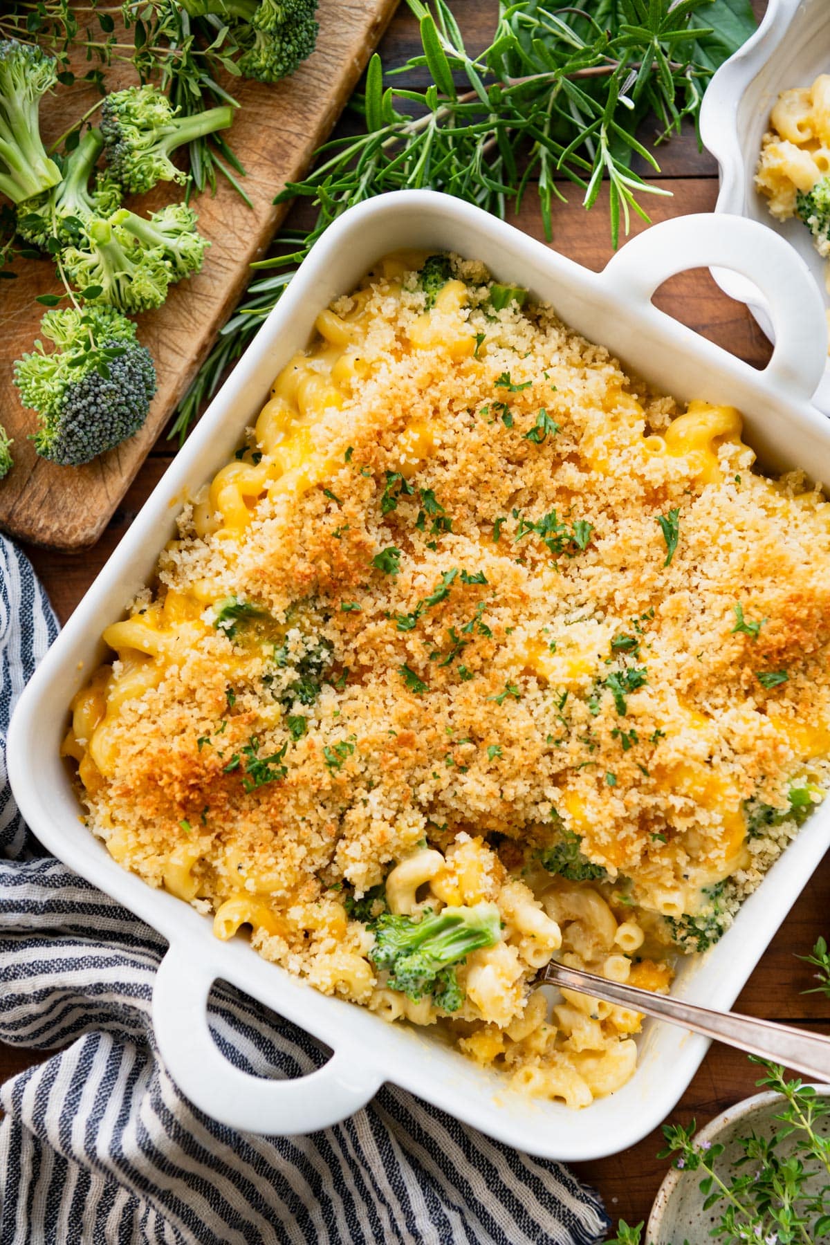 Close overhead image of broccoli mac and cheese in a white baking dish.
