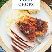 Cajun pork chops on a plate with text title overlay.