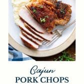 Plate of cajun pork chops with text title at the bottom.