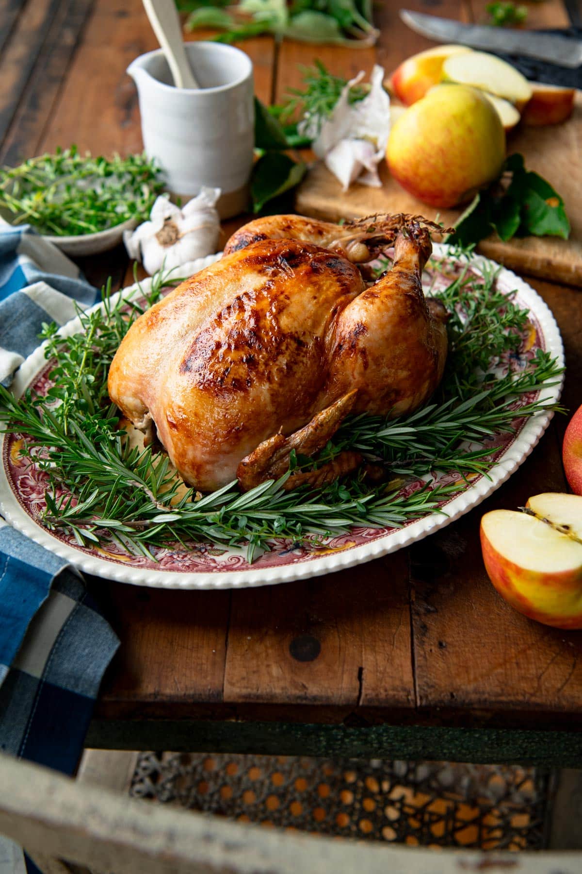 Cider glazed whole roasted chicken on a table.