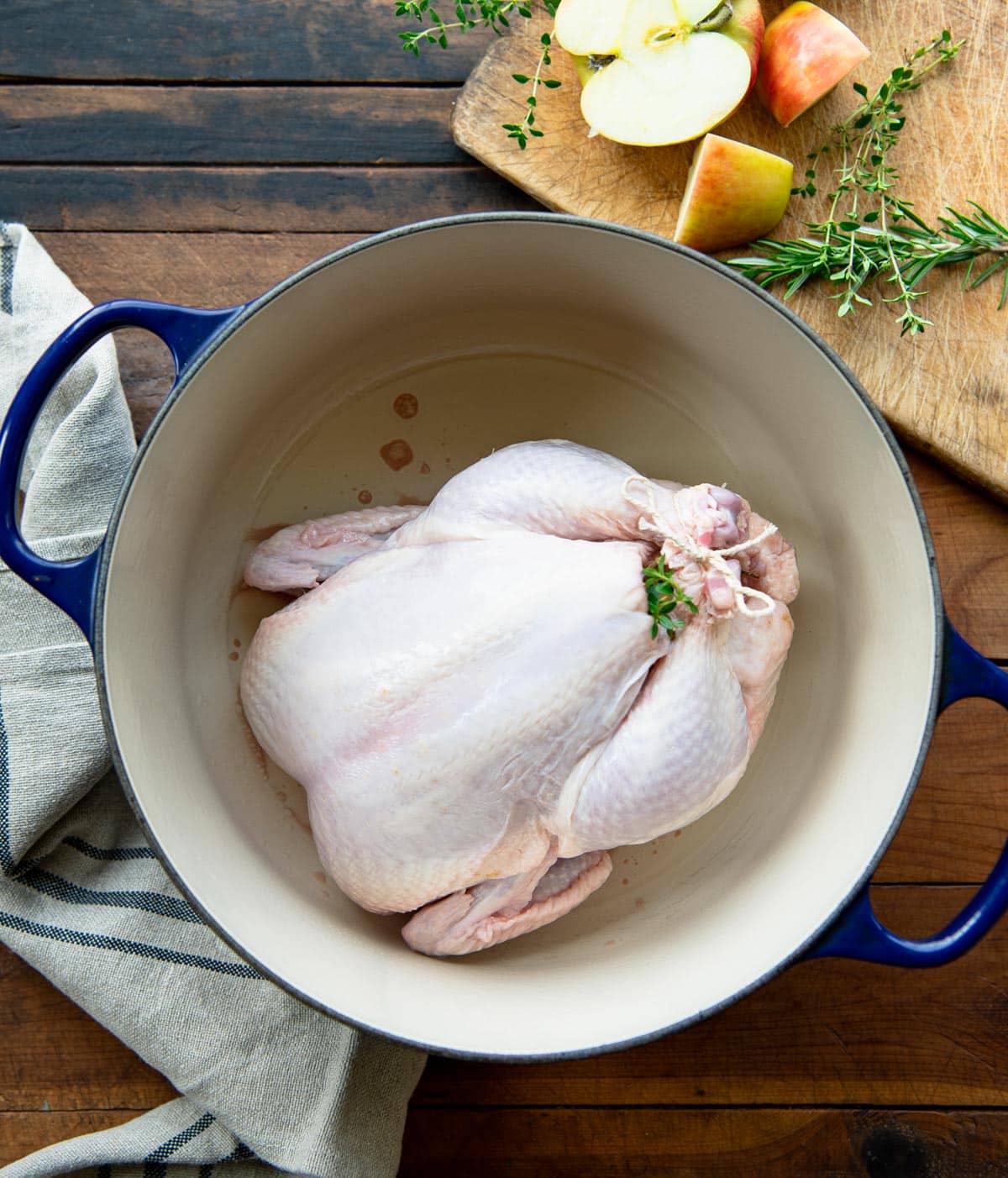 Whole chicken in a Dutch oven before roasting.
