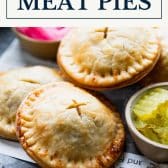Ground beef and cheddar meat pies with text title box at top.