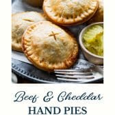 Ground beef and cheddar meat pies with text title at bottom.