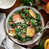 Square overhead shot of kale apple salad with bacon and creamy poppy seed dressing.