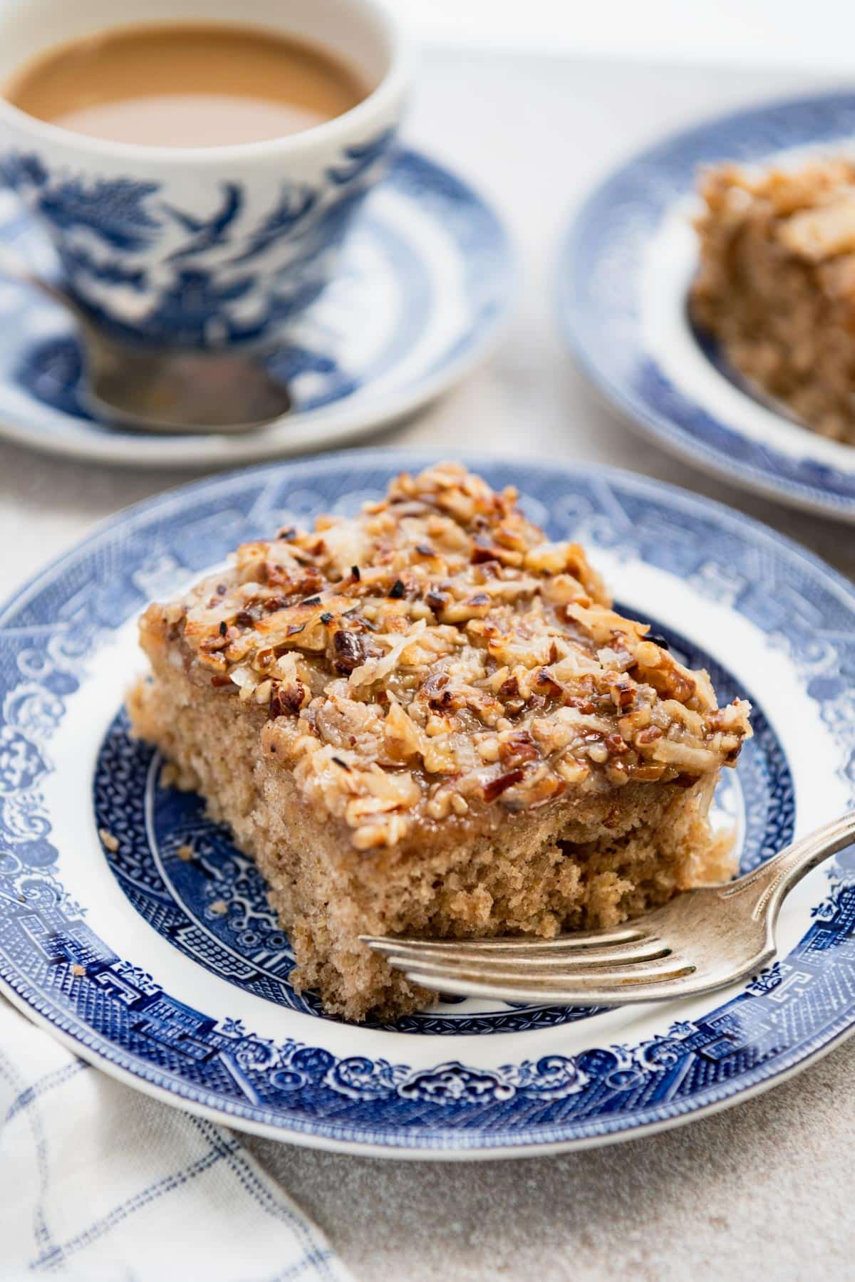 Piece of old fashioned oatmeal cake recipe served on a blue and white plate.