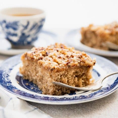 Square side shot of a slice of oatmeal cake on a blue and white plate.
