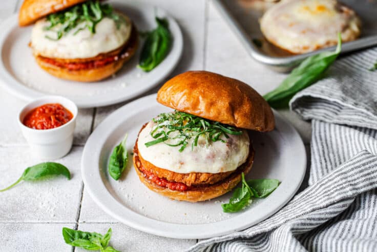 Process shot showing how to assemble a 5 ingredient chicken parm sandwich.