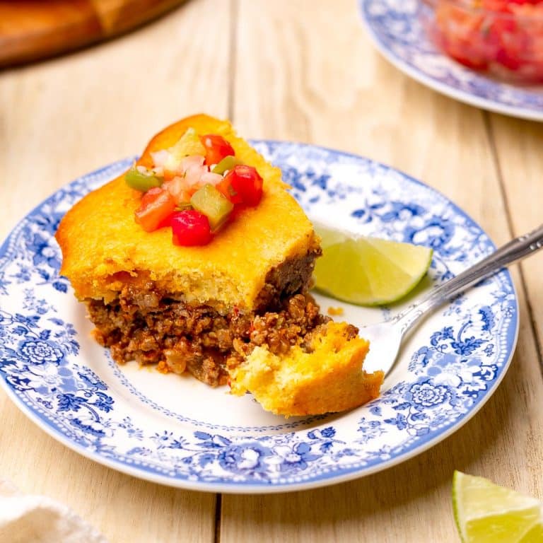 Square side shot of a slice of taco pie with Jiffy cornbread crust.