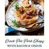 Close up side shot of smothered Crock Pot pork chops with bacon and onion and text title at the bottom.