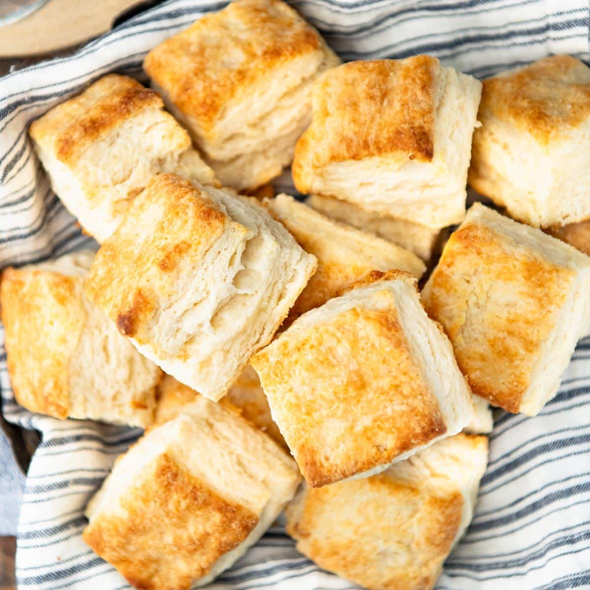 Overhead shot of a basket of flaky biscuits with layers.
