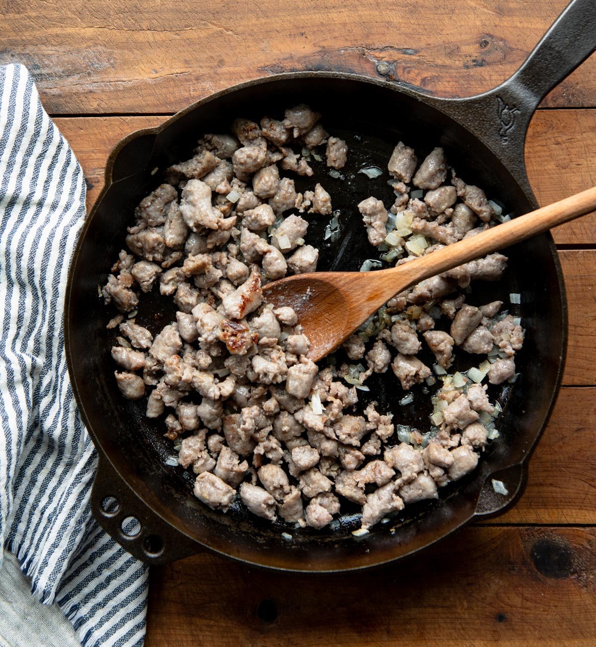 Browning maple breakfast sausage in a skillet.