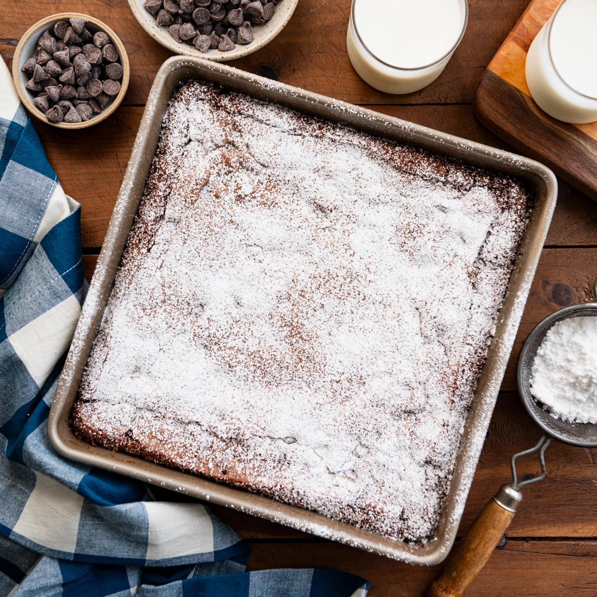 Overhead image of a pan of homemade brownies dusted with powdered sugar.