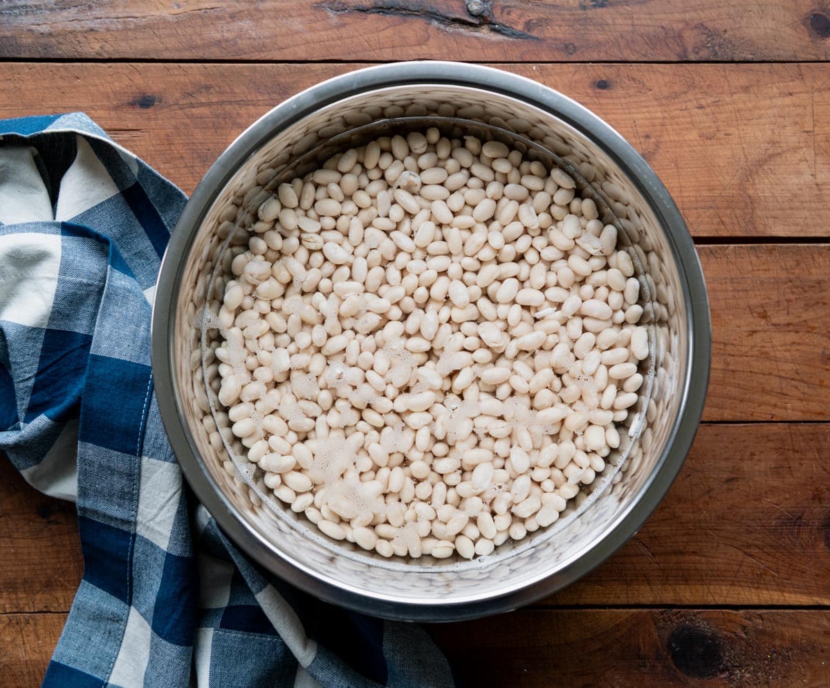 Soaking navy beans in a bowl.