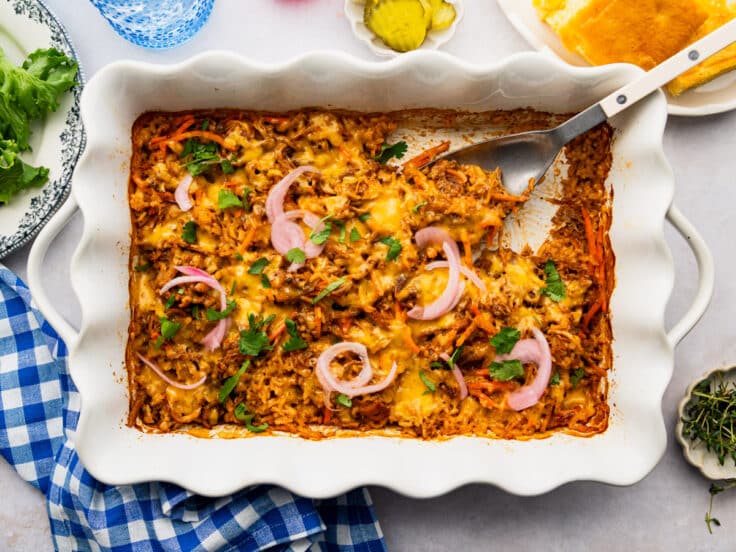 Horizontal overhead shot of a bbq pulled pork casserole in a white baking dish.