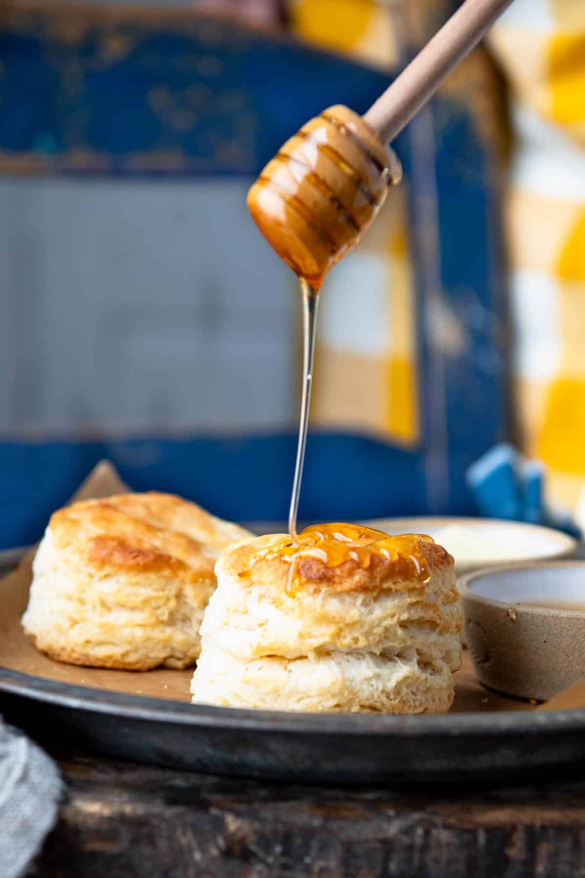 Drizzling honey over 3 ingredient buttermilk biscuits.