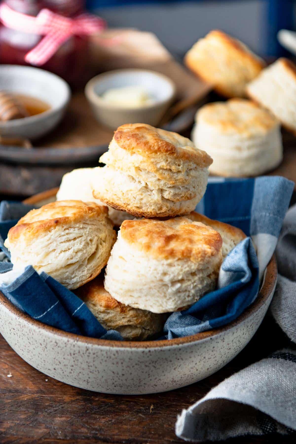 Close side shot of 3 ingredient buttermilk biscuits in a bowl on a breakfast table.