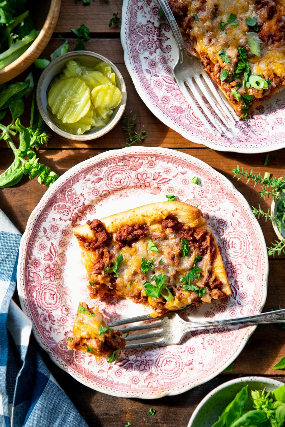Overhead shot of a slice of sloppy joe casserole on a red and white plate.