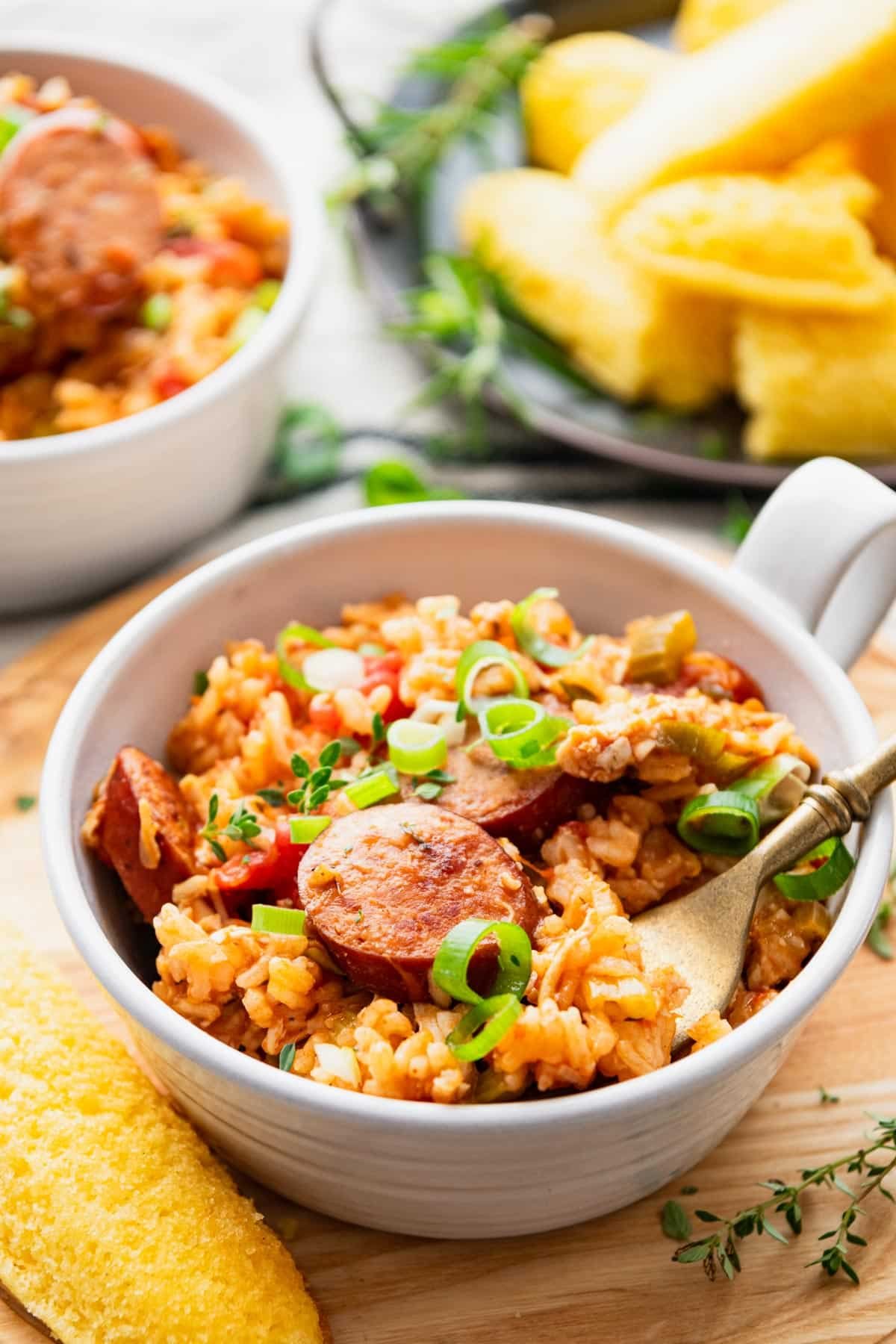 Close up side shot of a white bowl full of the best chicken and sausage jambalaya recipe.