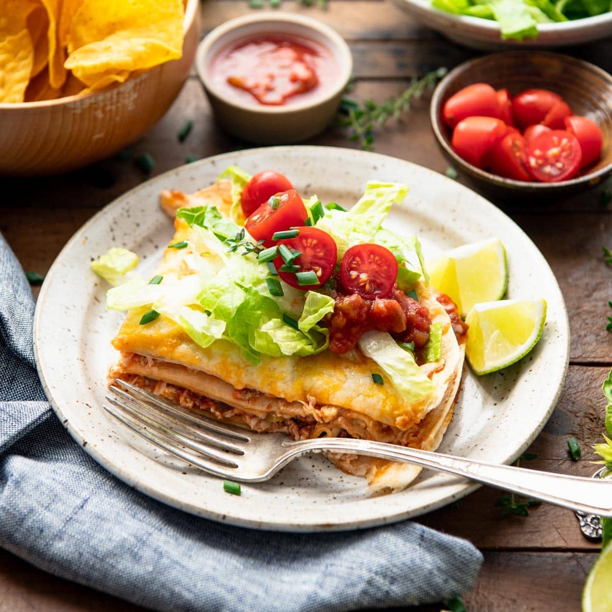 Square side shot of a slice of healthy chicken quesadilla casserole on a plate