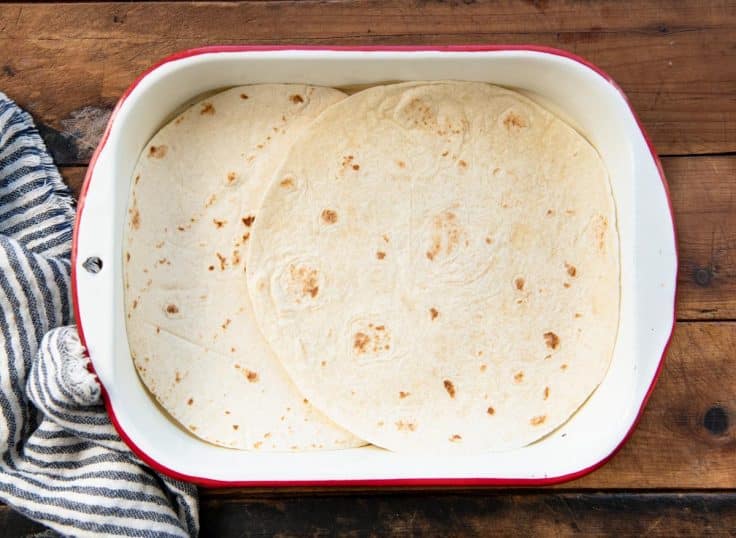Flour tortillas in a baking dish.