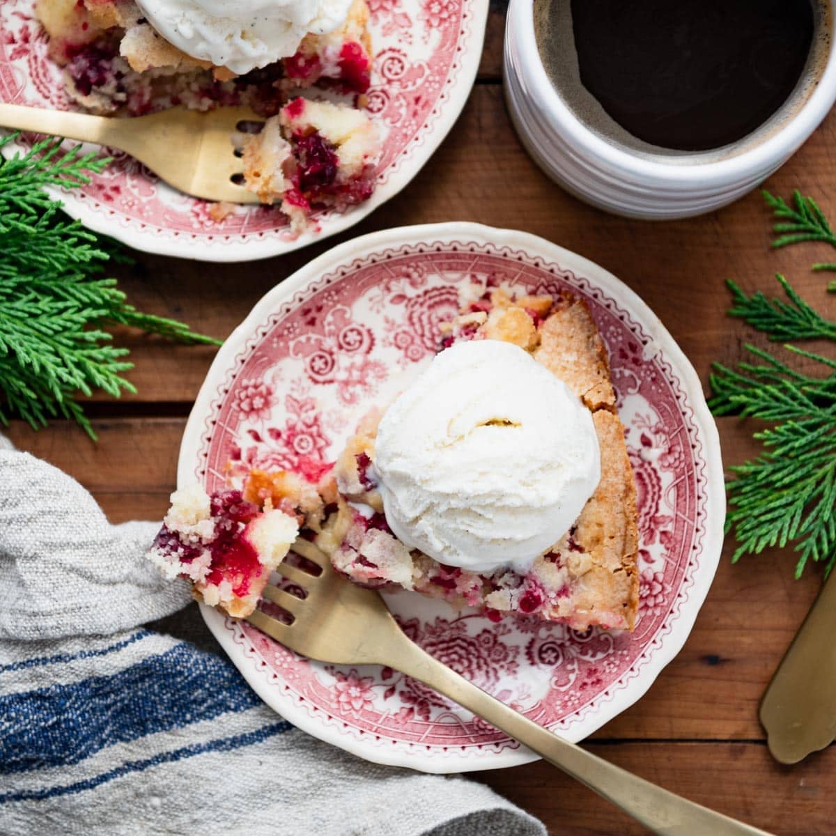 Square overhead shot of a slice of easy cranberry pie on a wooden table.