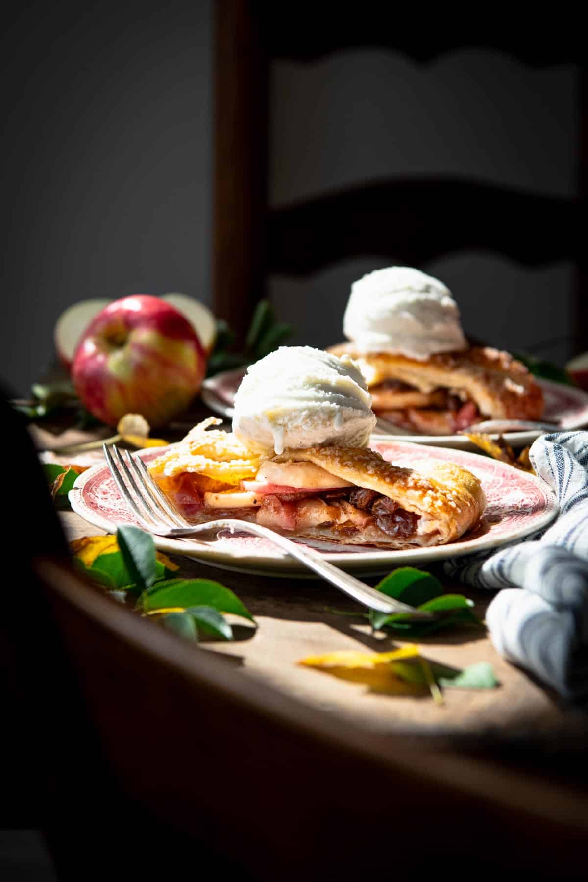 Ray of sunlight streaming in on a plate of easy apple strudel recipe.