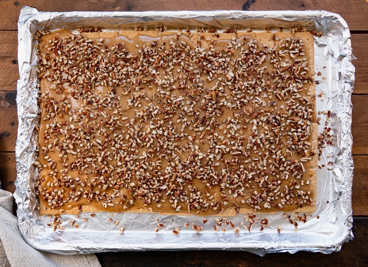 Process shot showing how to make graham cracker toffee bars.