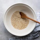 Soaking quick oats in hot water.