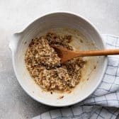 Stirring together coconut pecan broiled topping for oatmeal cake recipe.