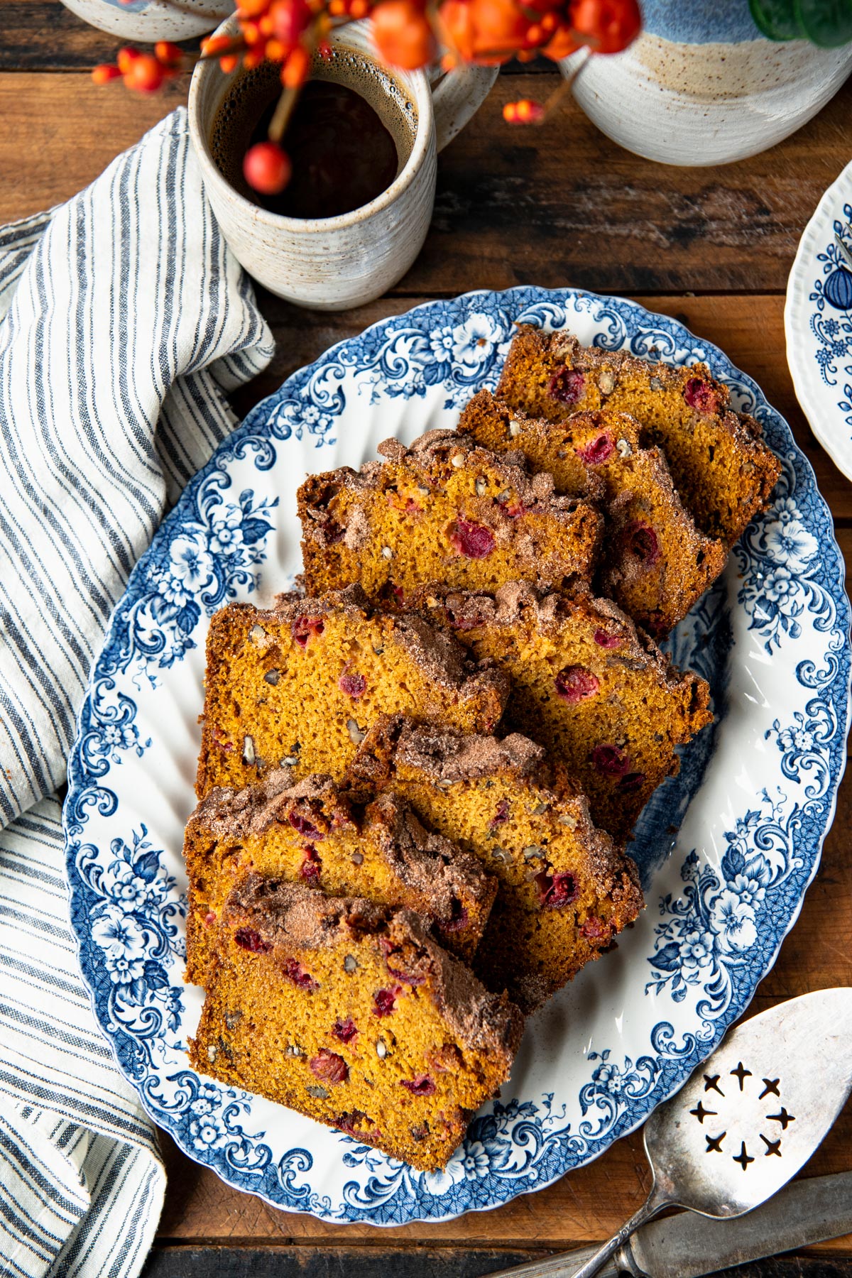 Overhead image of a tray of slices of the best pumpkin cranberry bread recipe.