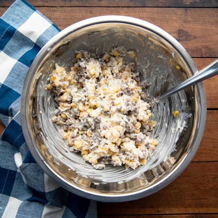 Process shot showing how to make sausage dip.