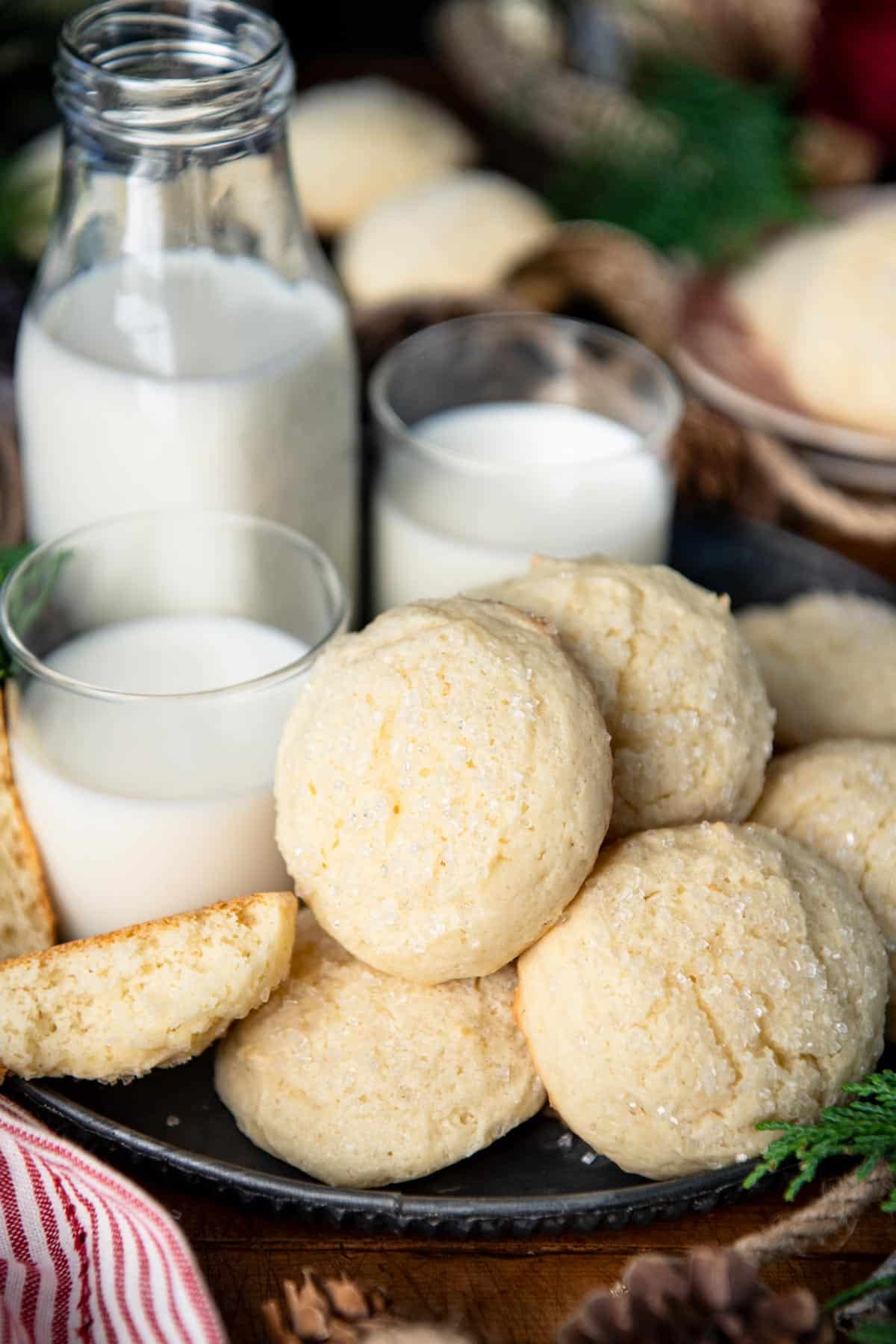 Close up shot of the best drop sugar cookies on a table with a side of milk.