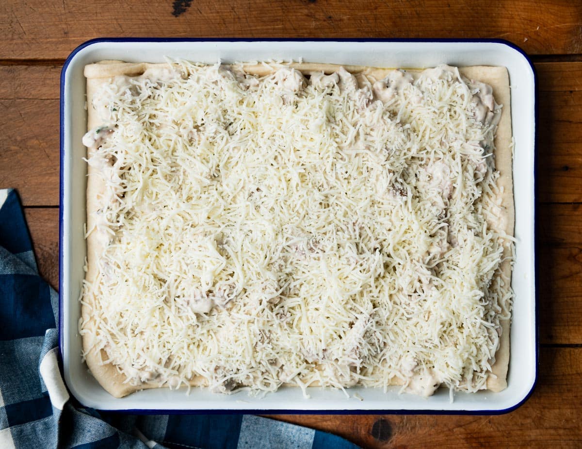 Chicken alfredo crescent roll bake in a pan before baking.