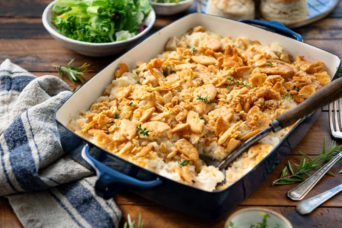 Horizontal side shot of a chicken and rice casserole in a blue baking dish.