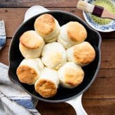 Baked cream biscuits in a cast iron skillet.