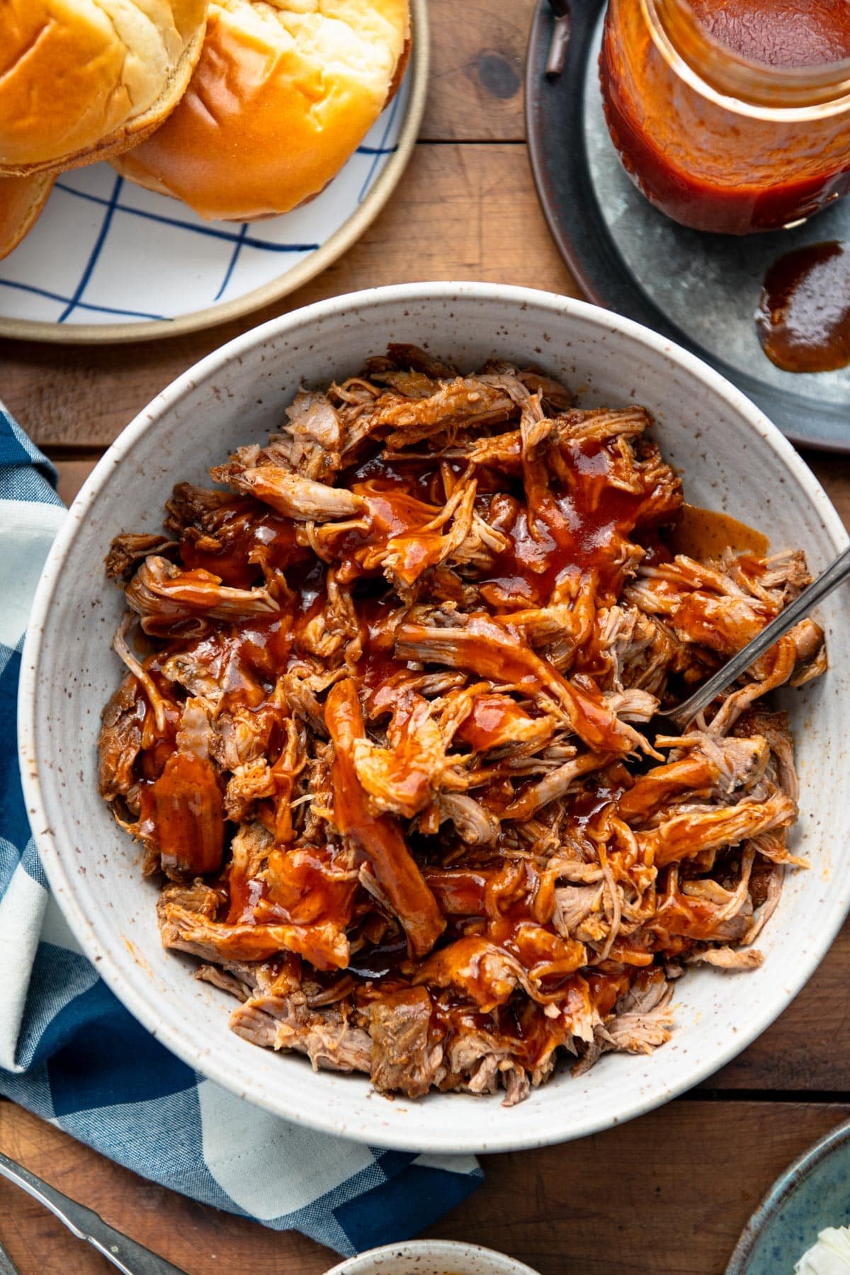 Close overhead image of a bowl of slow cooker beer pulled pork with homemade bbq sauce.
